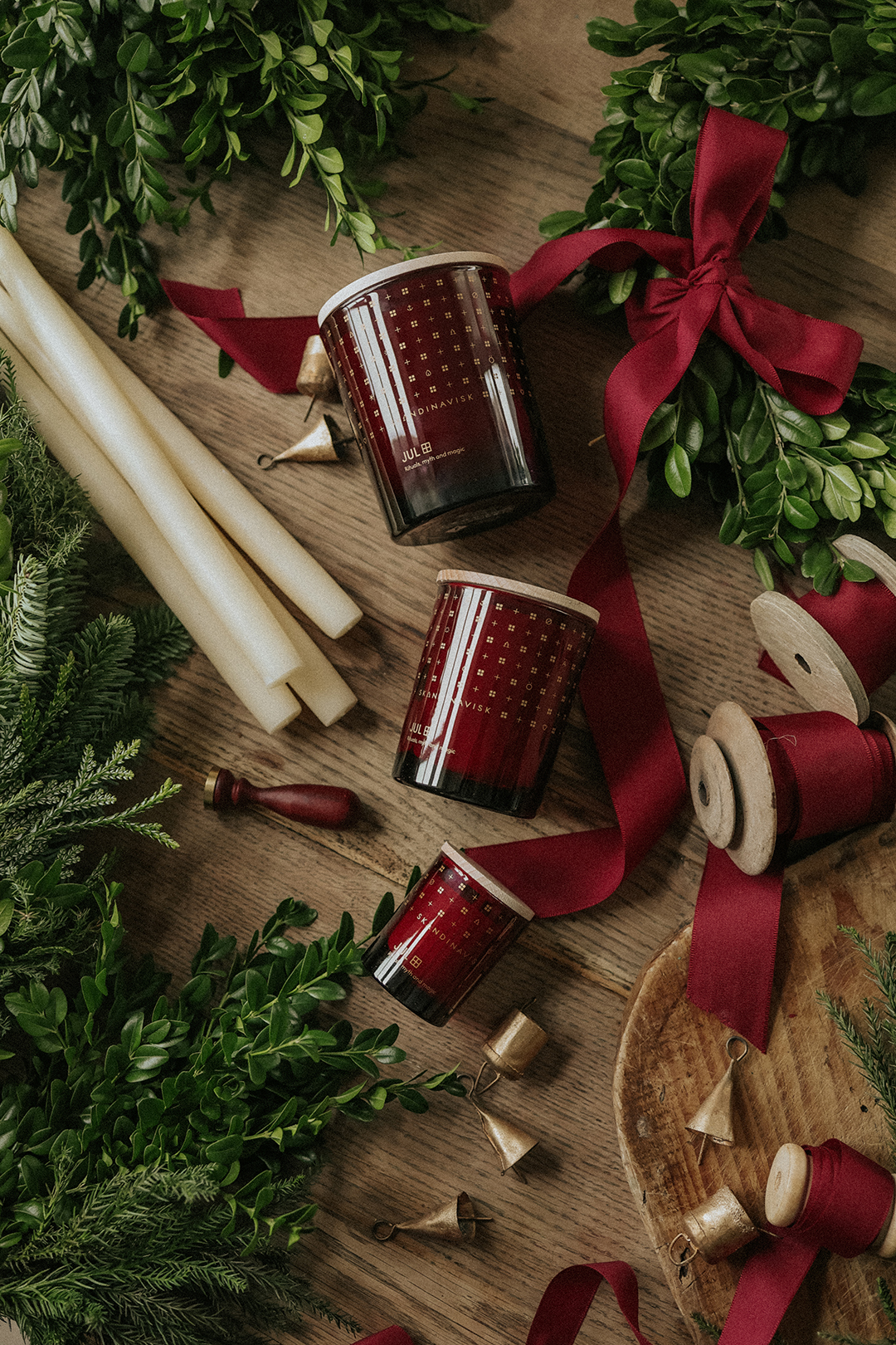 JUL Christmas scented candles on a wooden table among Scandinavian Christmas decorations